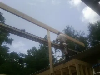 Carpenter setting a ridge beam over a new addition frame — Ice Dam Removal by Roofing Brothers in West Hartford