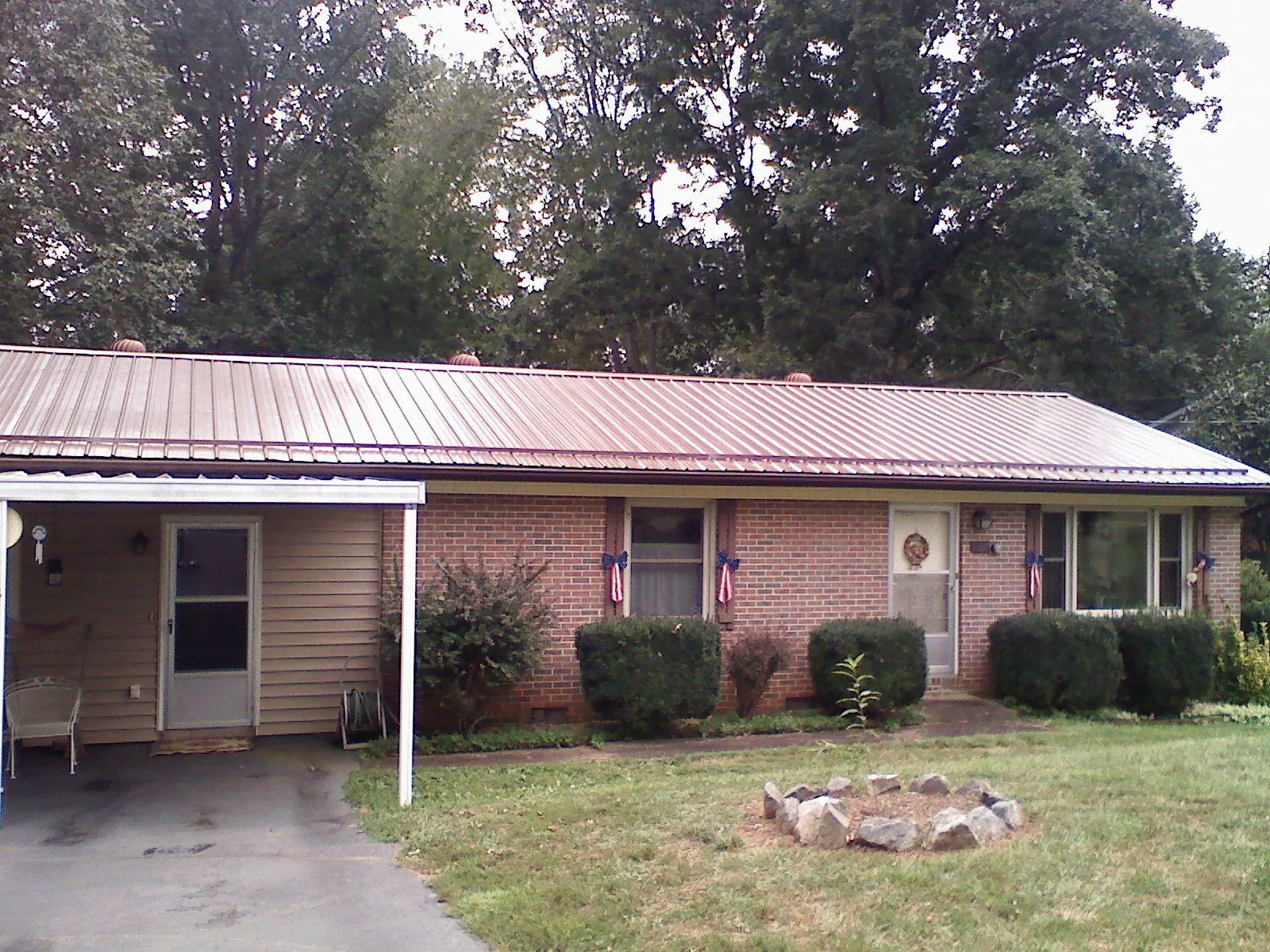 Bronze metal roof and carport on a brick ranch home — Roof Repair work by our crew in West Hartford
